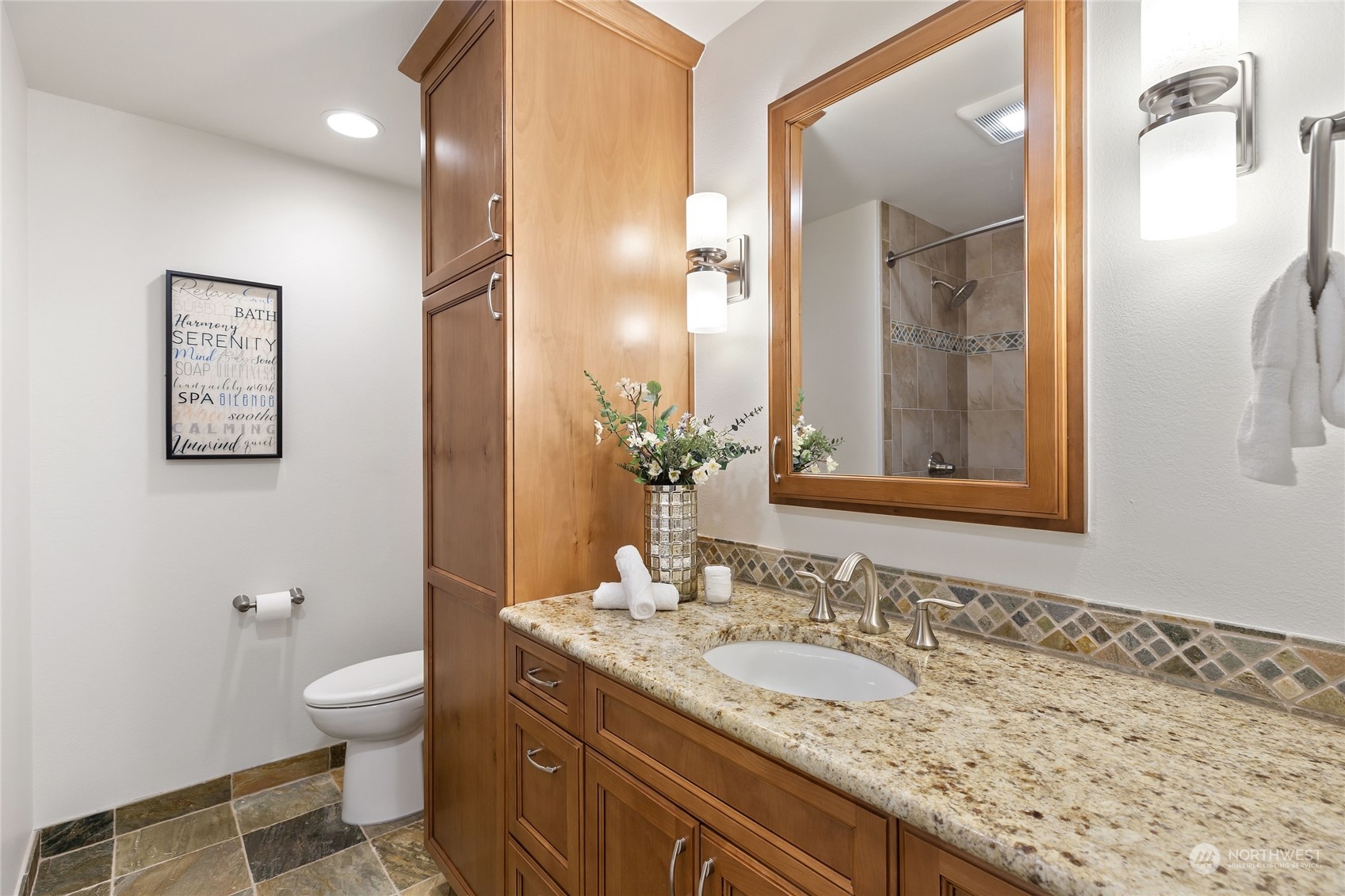 21020 49th Avenue Southeast Bothell, WA 98021 - Photo 31 of 39 a bathroom with a granite countertop sink a toilet and a mirror