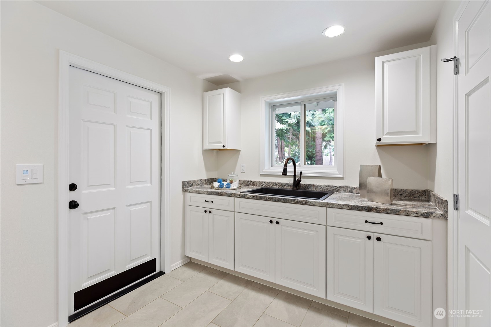 21020 49th Avenue Southeast Bothell, WA 98021 - Photo 32 of 39 a kitchen with stainless steel appliances granite countertop a sink a window and white cabinets