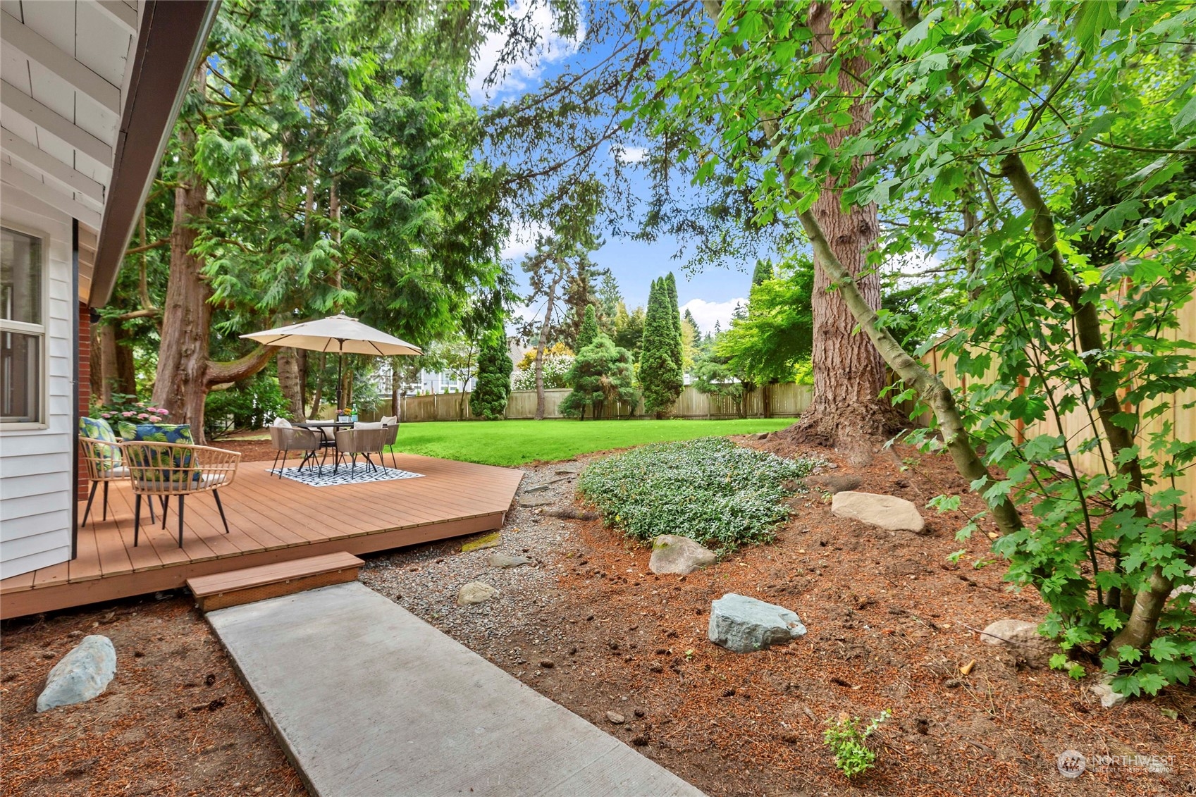 21020 49th Avenue Southeast Bothell, WA 98021 - Photo 35 of 39 a view of a patio with a table and chairs under an umbrella