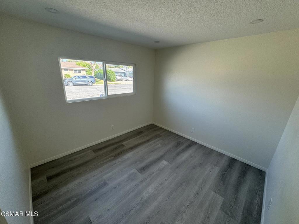 1769 Sitka Avenue Simi Valley, CA 93063 - Photo 6 of 11 an empty room with wooden floor and windows