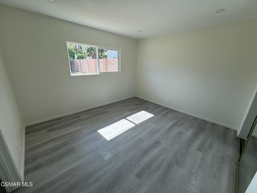 1769 Sitka Avenue Simi Valley, CA 93063 - Photo 8 of 11 an empty room with wooden floor and windows