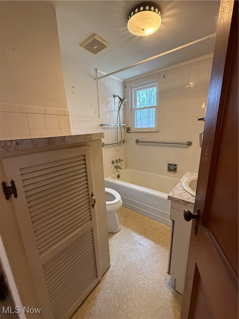 3122 South Medina Line Road Wadsworth, OH 44281 - Photo 26 of 41 Bathroom featuring visible vents, toilet, vanity, and shower / bathtub combination