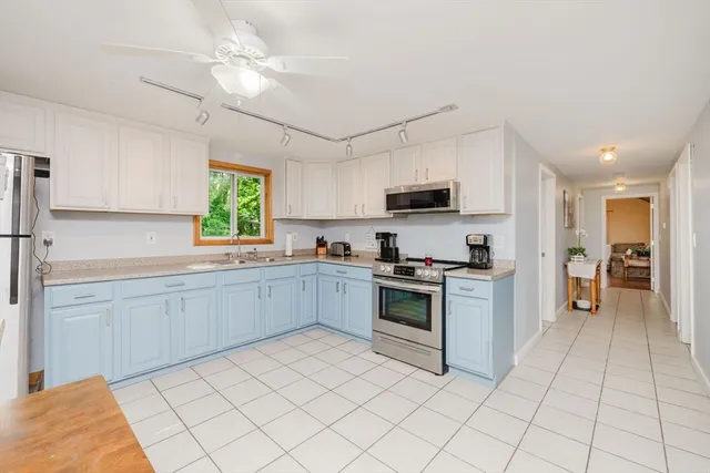 a kitchen with a stove a sink and a microwave