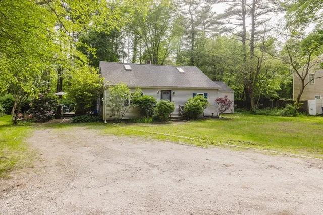 a view of a house with a yard and basketball court