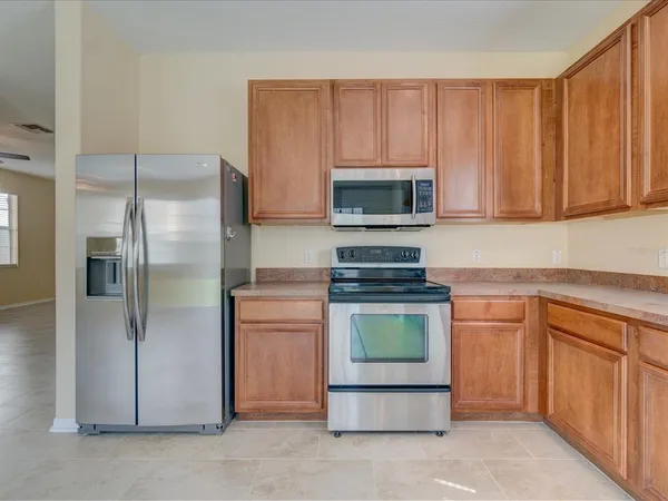 a kitchen with a refrigerator stove and microwave