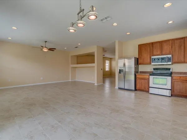 a view of a kitchen with stainless steel appliances a refrigerator counter top space