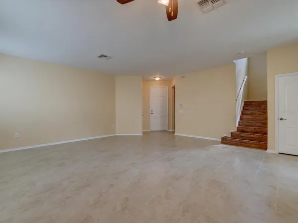 a view of an empty room with stairs