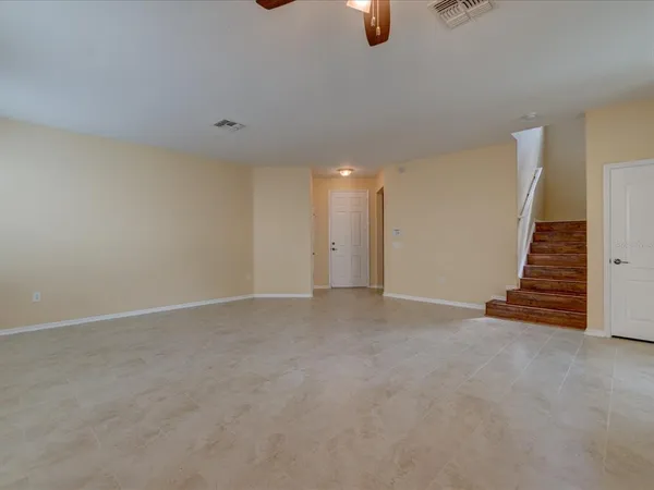 a view of an empty room with stairs
