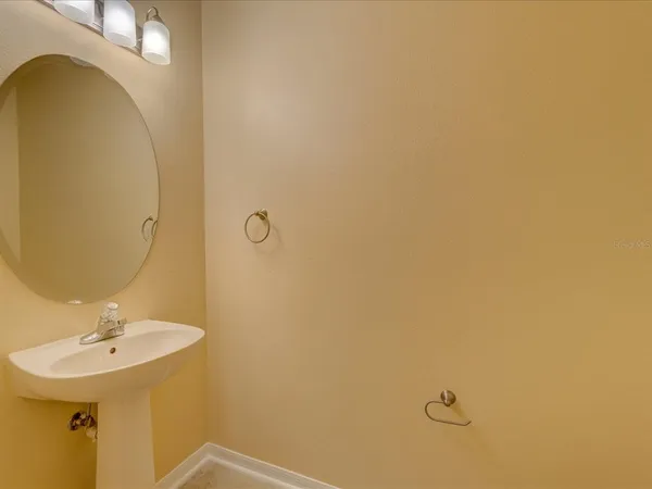 a bathroom with a sink a mirror and vanity
