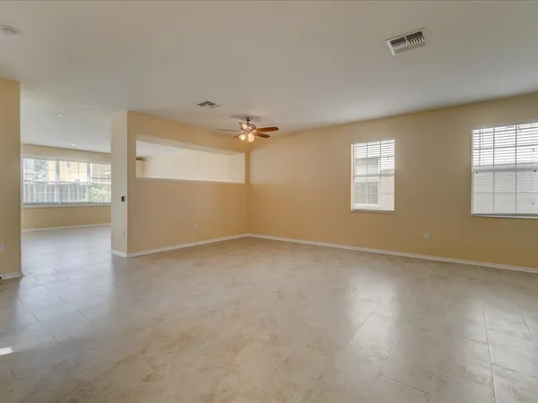 an empty room with windows and closet