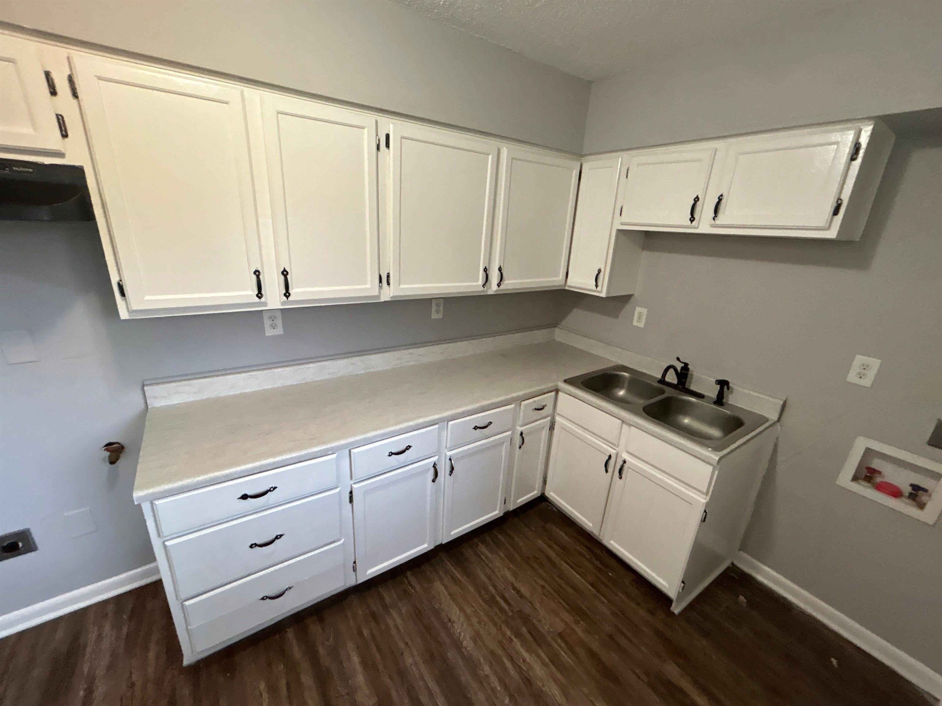 3509 Brantley Road Memphis, TN 38109 - Photo 6 of 9 a kitchen with granite countertop white cabinets and white appliances