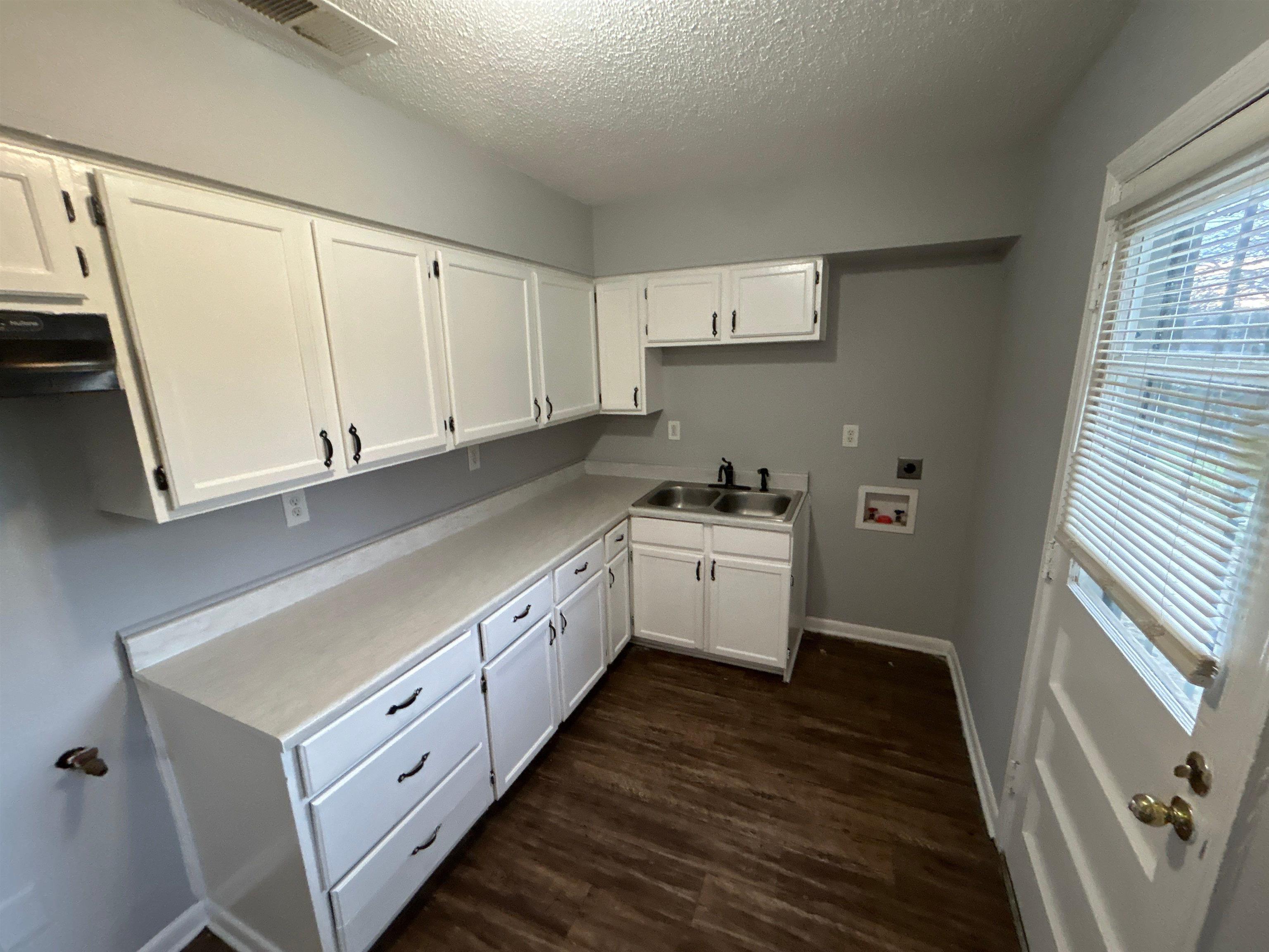 3509 Brantley Road Memphis, TN 38109 - Photo 7 of 9 a kitchen with granite countertop white cabinets and white appliances