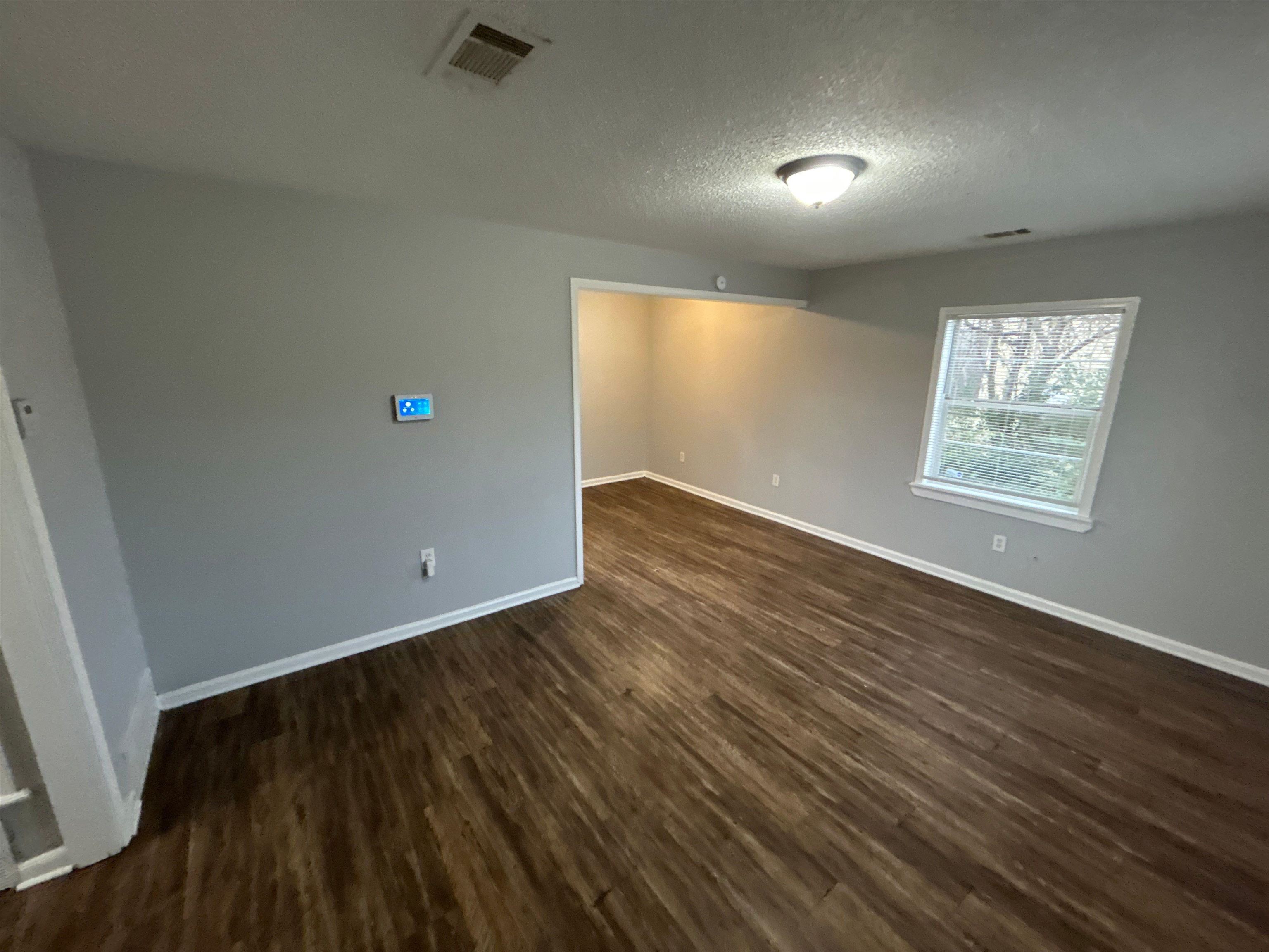 3509 Brantley Road Memphis, TN 38109 - Photo 8 of 9 an empty room with wooden floor and windows