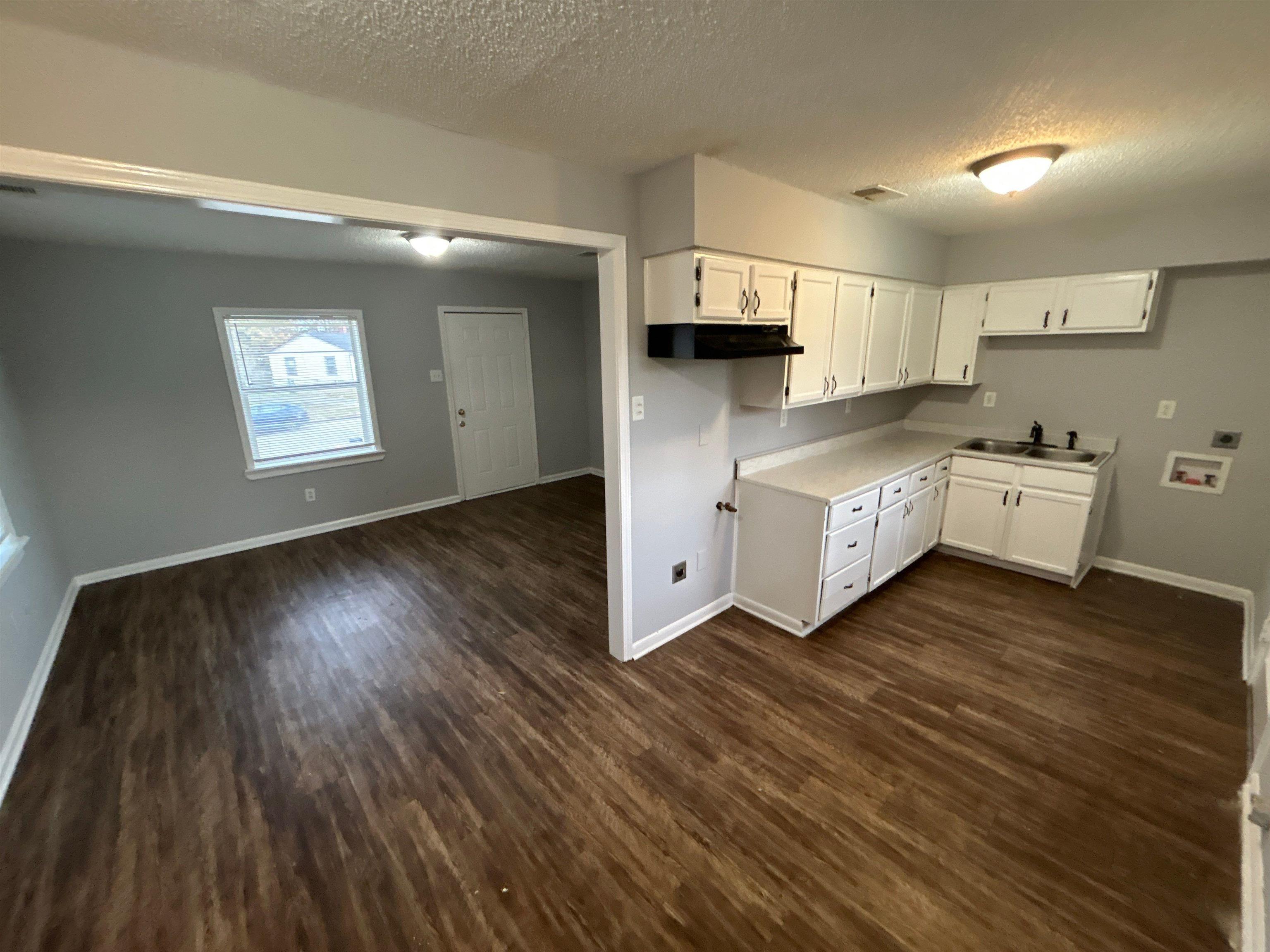 3509 Brantley Road Memphis, TN 38109 - Photo 9 of 9 a living room with stainless steel appliances wooden floors and kitchen view