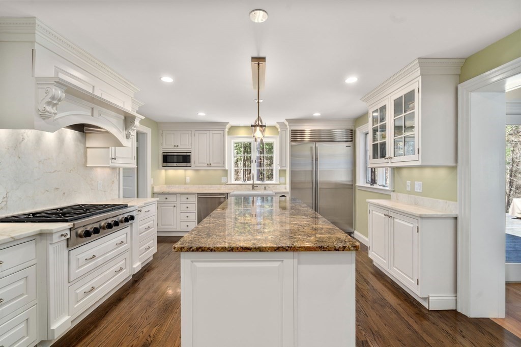 86 Concord Road Weston, MA 02493 - Photo 12 of 24 a kitchen with stainless steel appliances granite countertop a sink stove and refrigerator