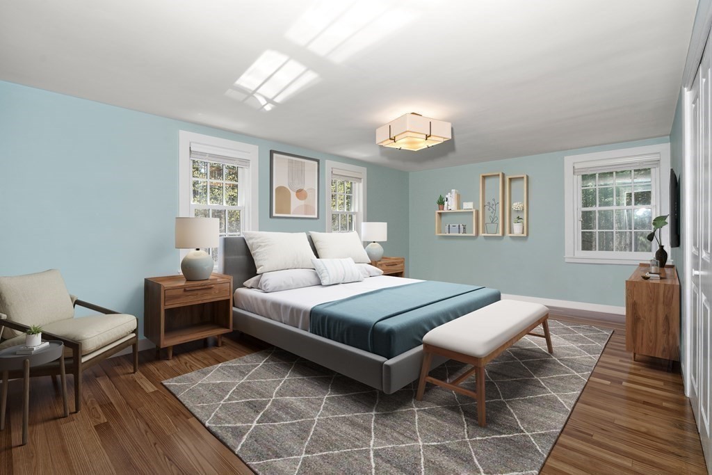 86 Concord Road Weston, MA 02493 - Photo 14 of 24 a bedroom with a bed and a table with wooden floor