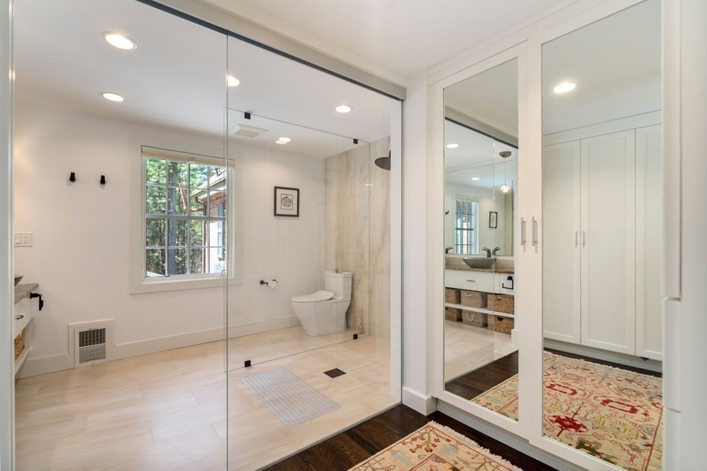 86 Concord Road Weston, MA 02493 - Photo 17 of 24 a bathroom with a glass shower door and a window