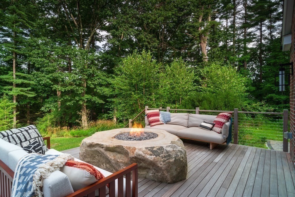 86 Concord Road Weston, MA 02493 - Photo 20 of 24 a view of a patio with lawn chairs wooden floor and fence