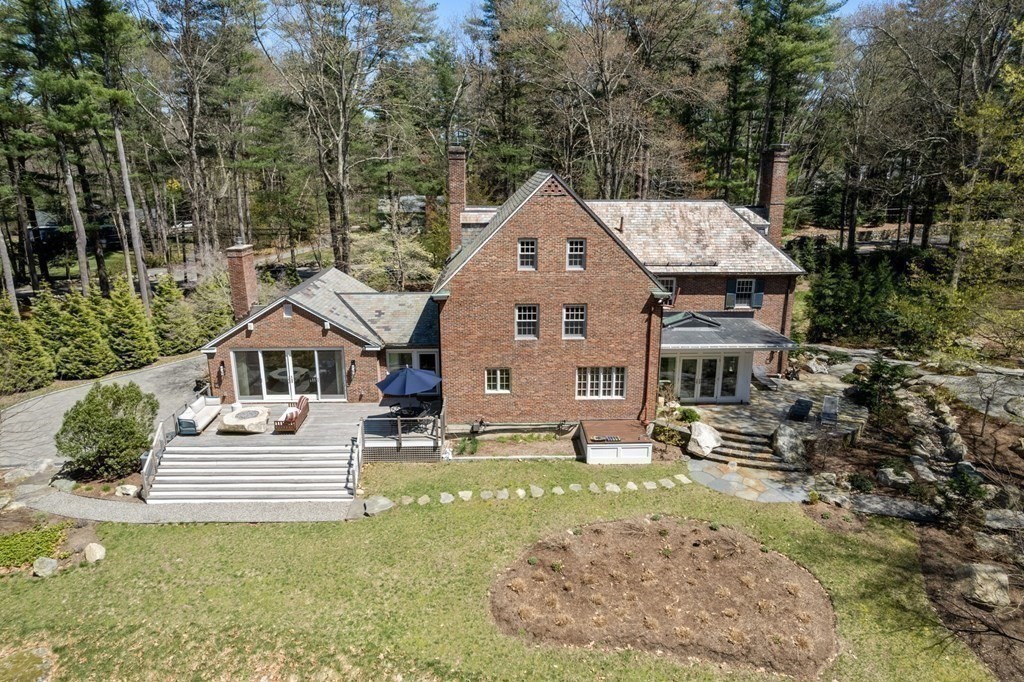 86 Concord Road Weston, MA 02493 - Photo 23 of 24 a view of a house with a yard patio and fire pit