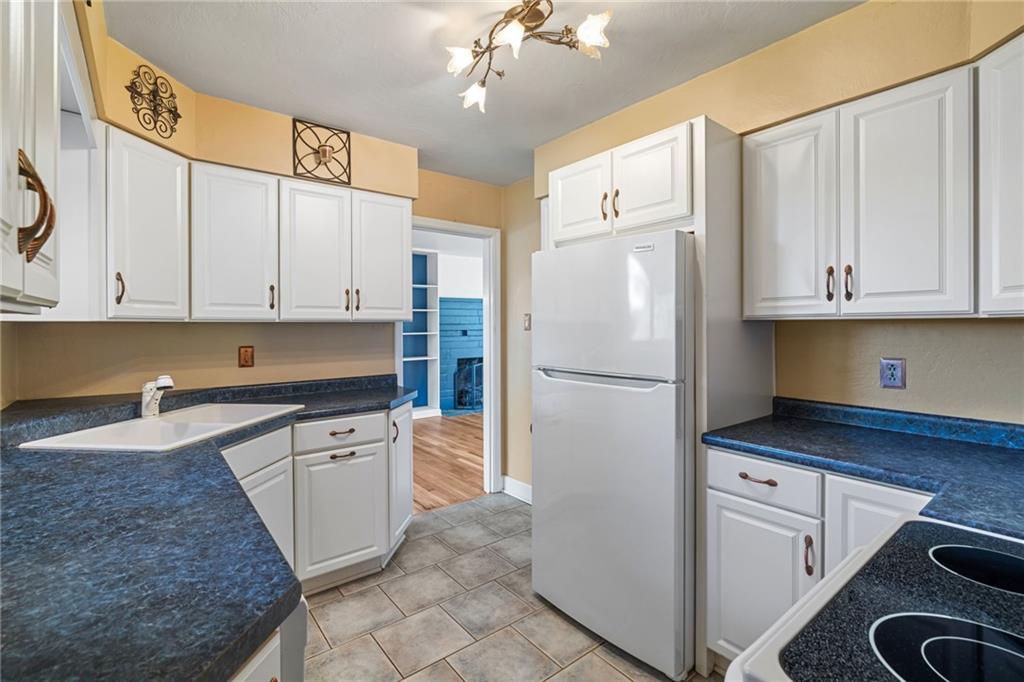 152 Easley Road Pittsburgh, PA 15237 - Photo 9 of 20 a kitchen with white cabinets and white appliances