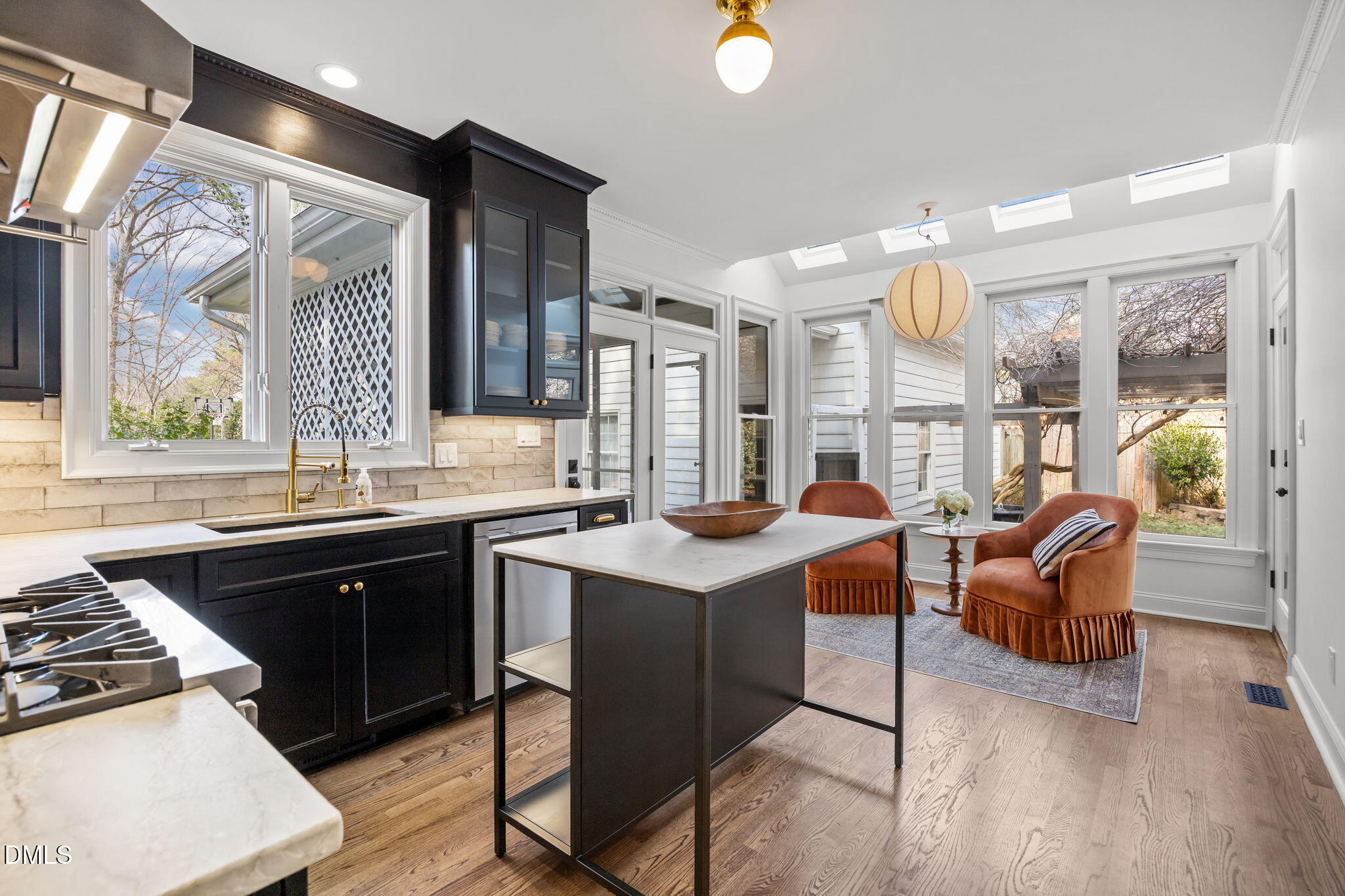 8805 Mourning Dove Road Raleigh, NC 27615 - Photo 16 of 55 a kitchen with a sink stove and wooden cabinets