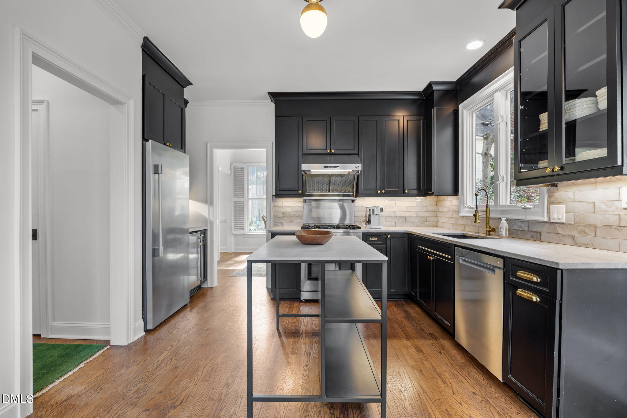 8805 Mourning Dove Road Raleigh, NC 27615 - Photo 19 of 55 a large kitchen with stainless steel appliances a large counter top space cabinets and wooden floor