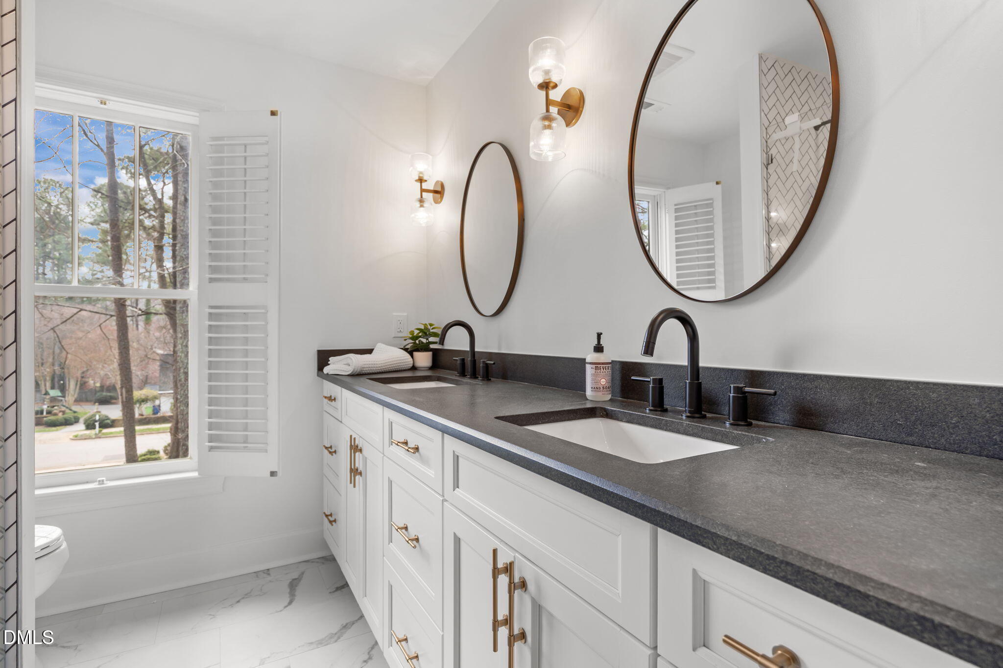 8805 Mourning Dove Road Raleigh, NC 27615 - Photo 27 of 55 a bathroom with a double vanity sink and a mirror