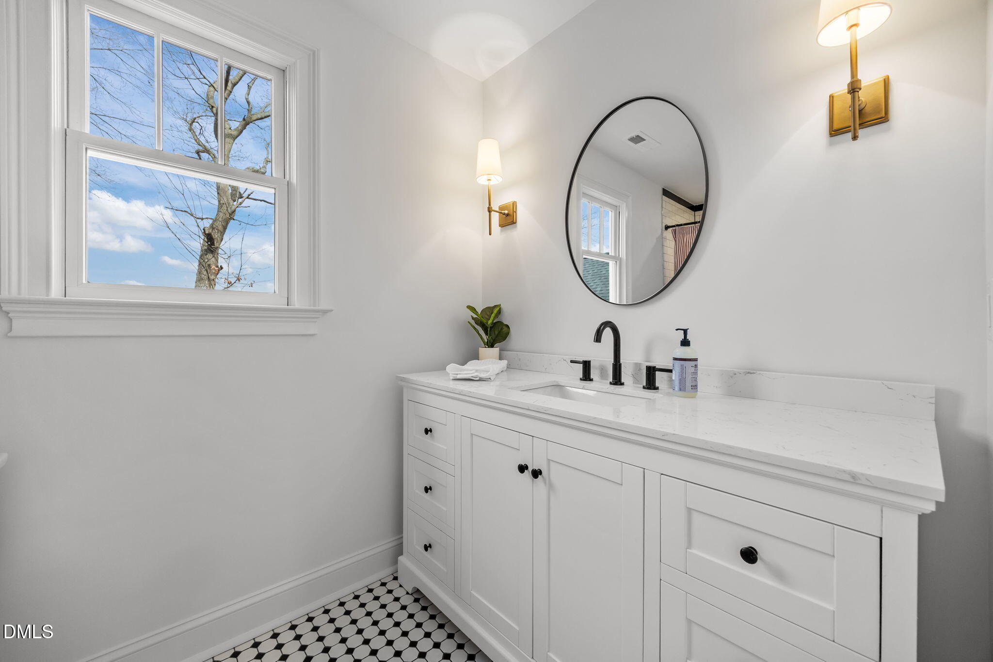 8805 Mourning Dove Road Raleigh, NC 27615 - Photo 32 of 55 a bathroom with a sink and a mirror