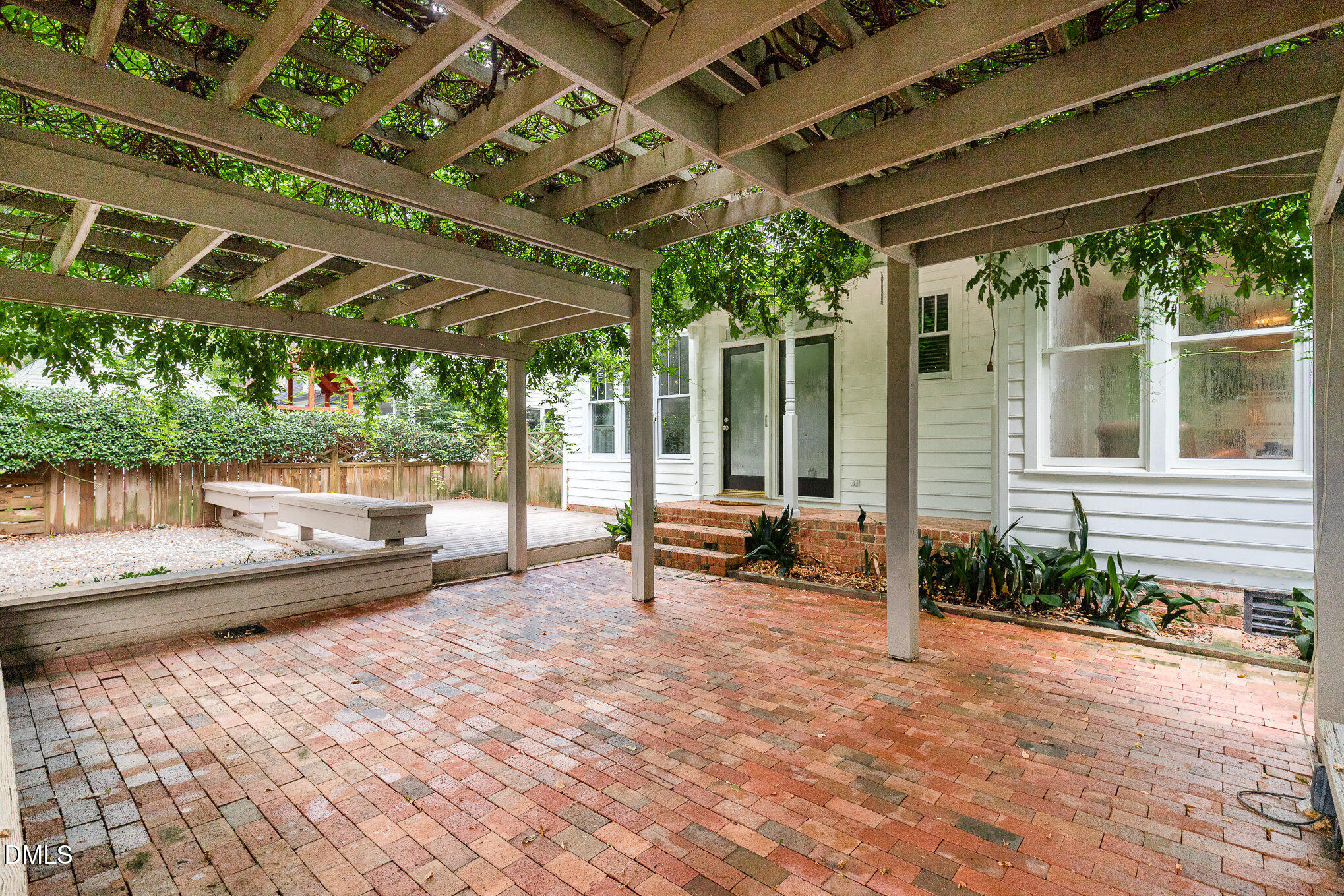 8805 Mourning Dove Road Raleigh, NC 27615 - Photo 44 of 55 a view of a patio with a table and chairs under an umbrella