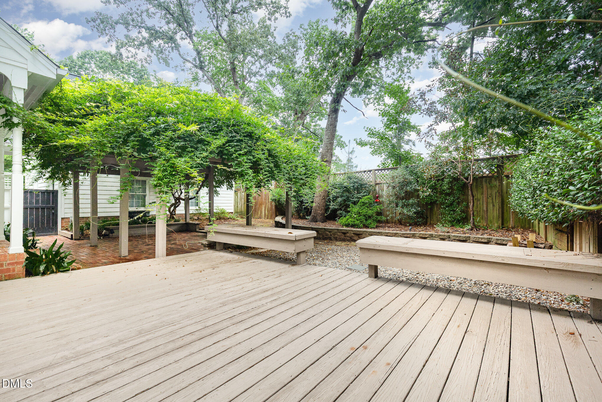 8805 Mourning Dove Road Raleigh, NC 27615 - Photo 45 of 55 a view of house with deck outdoor seating and covered with trees