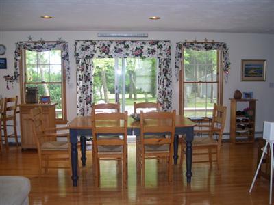 138 Mashnee Road Bourne, MA 02532 - Photo 3 of 15 a view of a dining room with furniture window and wooden floor