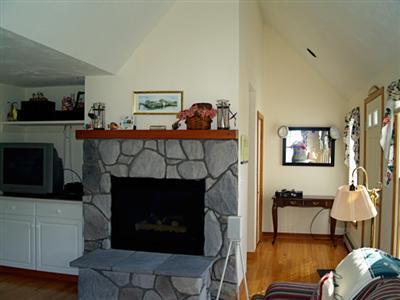 138 Mashnee Road Bourne, MA 02532 - Photo 5 of 15 a living room with furniture and a fireplace