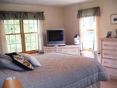138 Mashnee Road Bourne, MA 02532 - Photo 8 of 15 a bedroom with a bed and a flat tv screen
