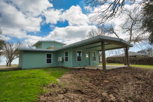 a backyard of a house with barbeque oven
