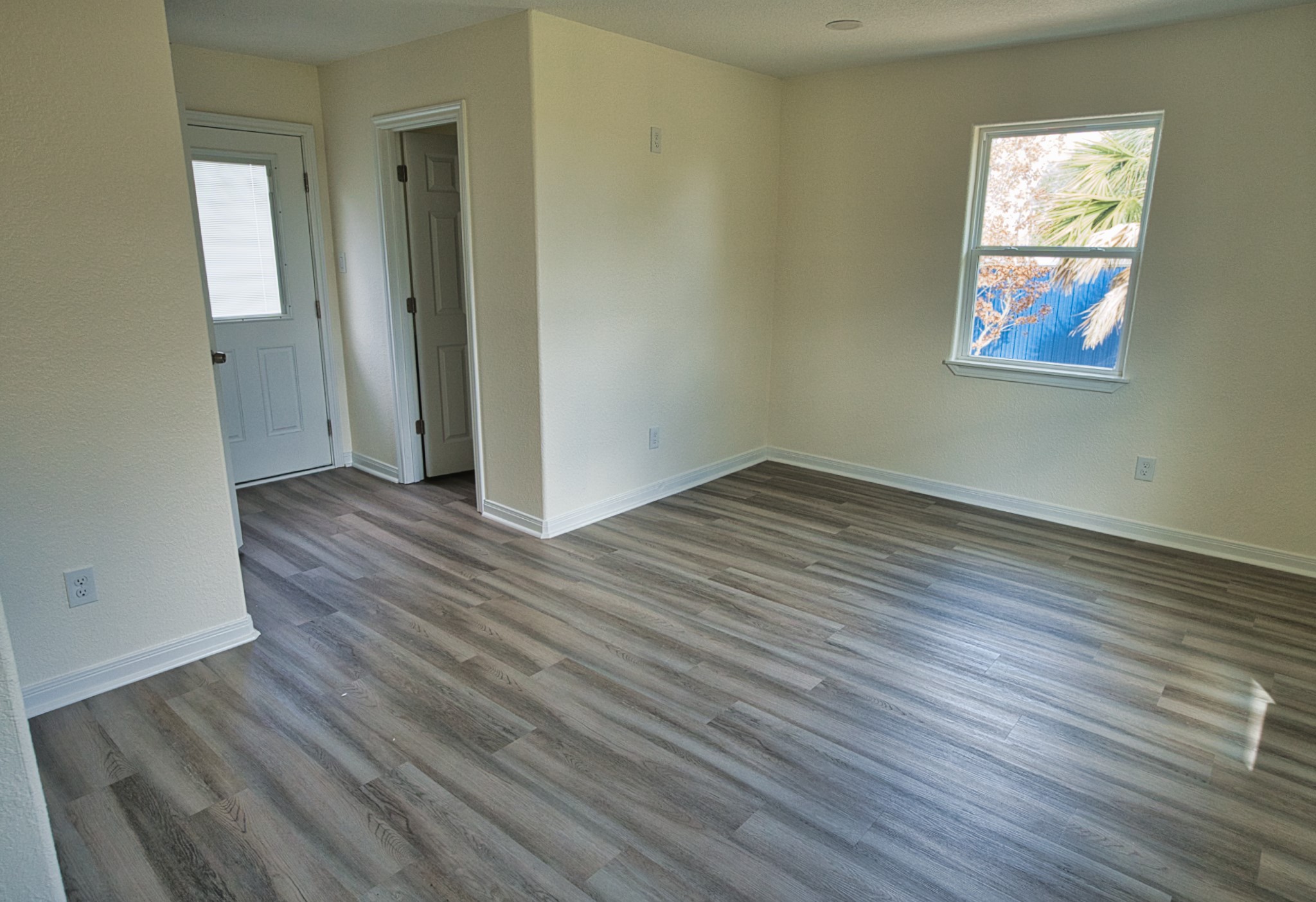 133 County Road 296 Sargent, TX 77414 - Photo 16 of 19 an empty room with wooden floor and windows