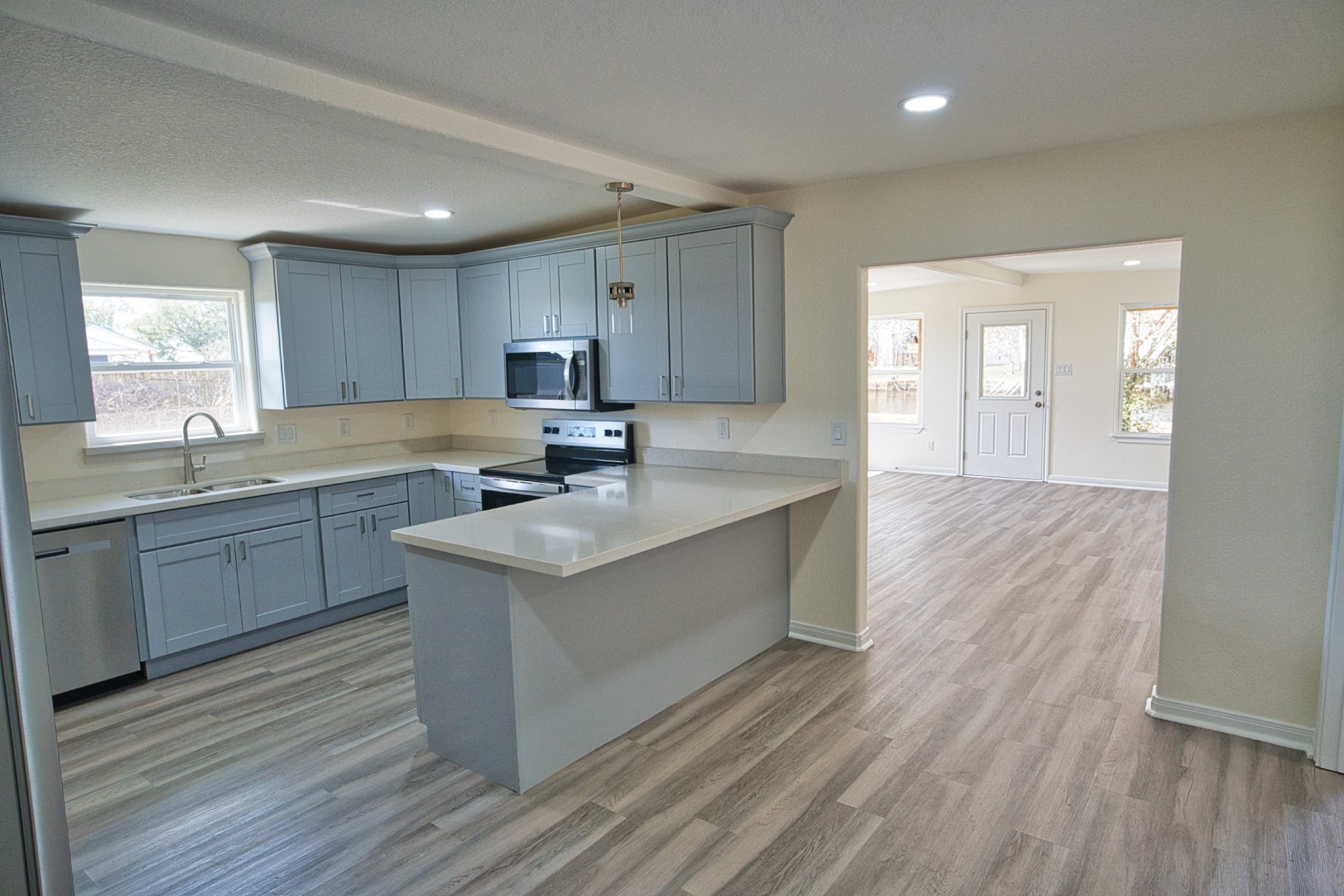 133 County Road 296 Sargent, TX 77414 - Photo 5 of 19 a kitchen with stainless steel appliances granite countertop a sink stove and cabinets