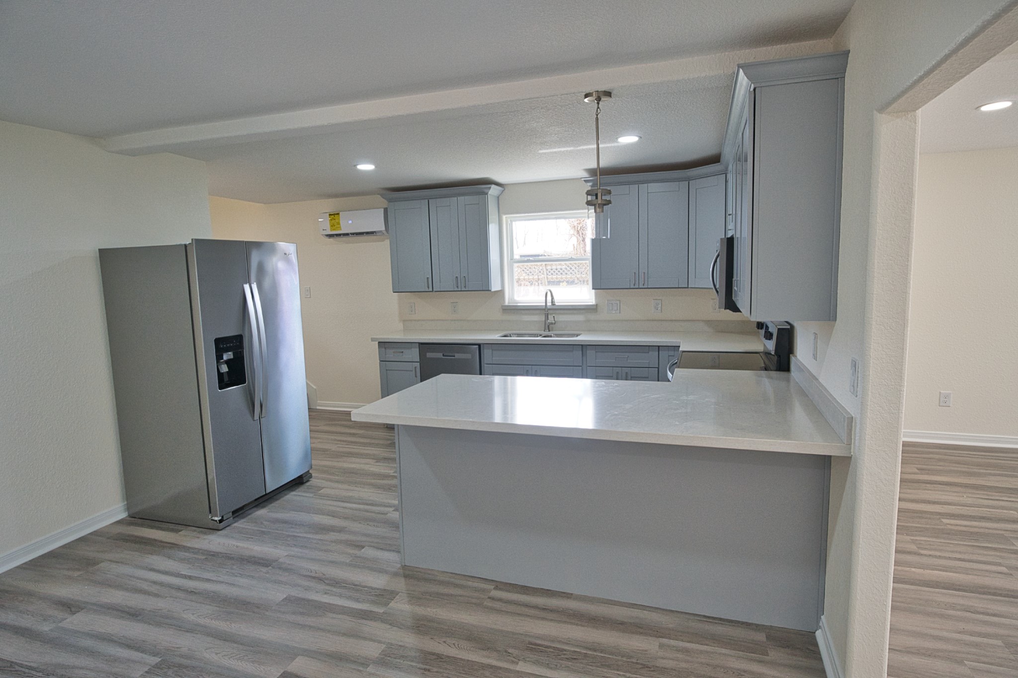 133 County Road 296 Sargent, TX 77414 - Photo 8 of 19 a large kitchen with a refrigerator and a sink