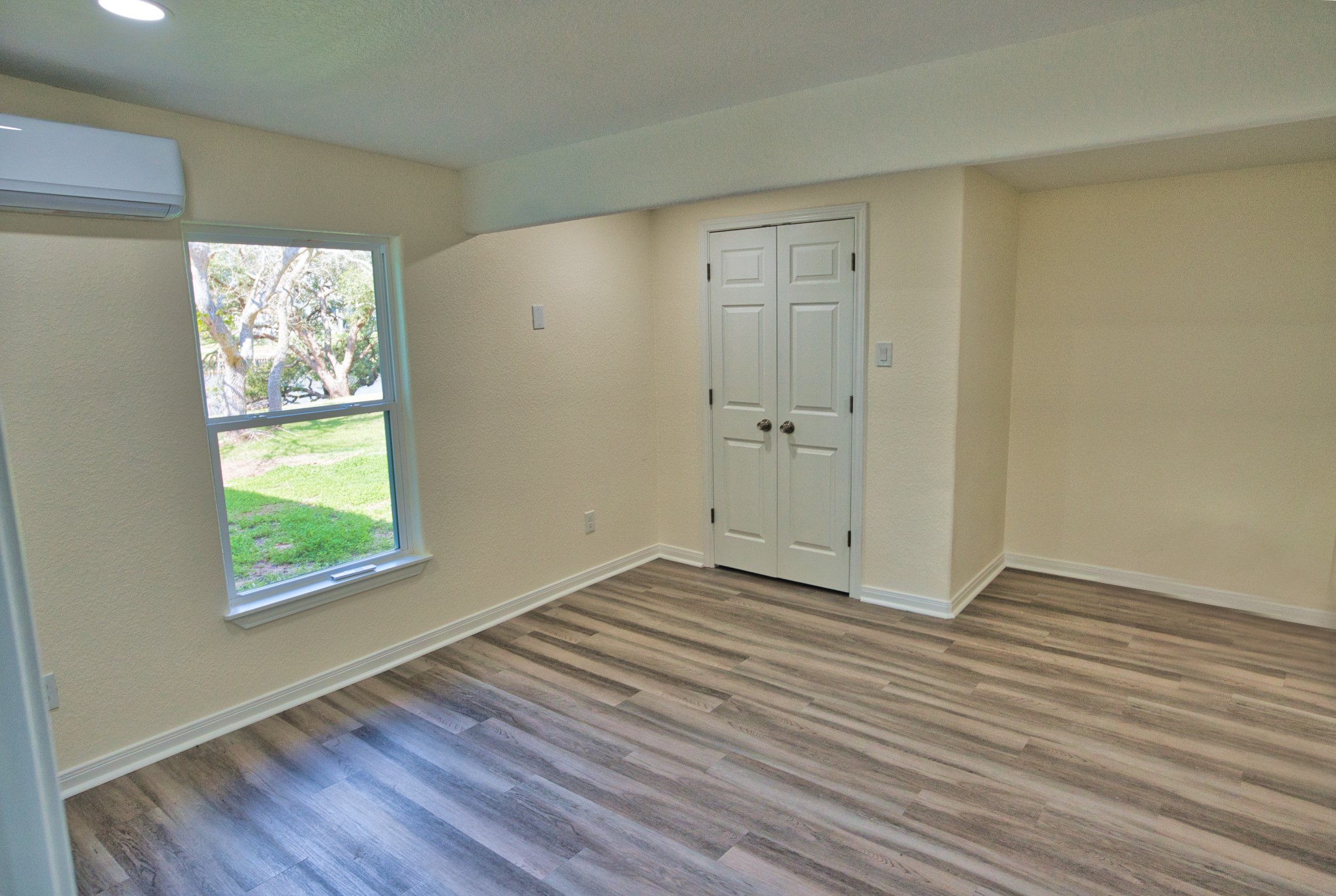 133 County Road 296 Sargent, TX 77414 - Photo 10 of 19 a view of an empty room with wooden floor and a window