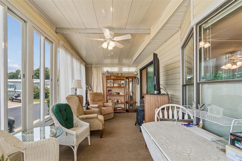 12501 Ulmerton Road, Unit 175 Largo, FL 33774 - Photo 2 of 32 a living room with furniture a chandelier and a large window