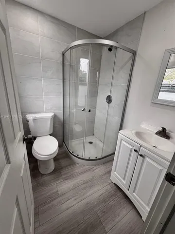 a view of a room with wooden floor and white walls