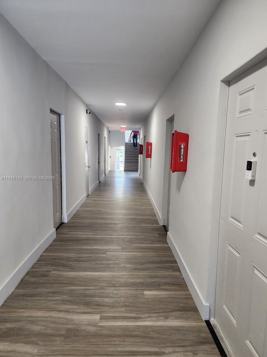 852 Southwest 13th Avenue, Unit 3 Miami, FL 33135 - Photo 4 of 20 a view of a hallway with wooden floor