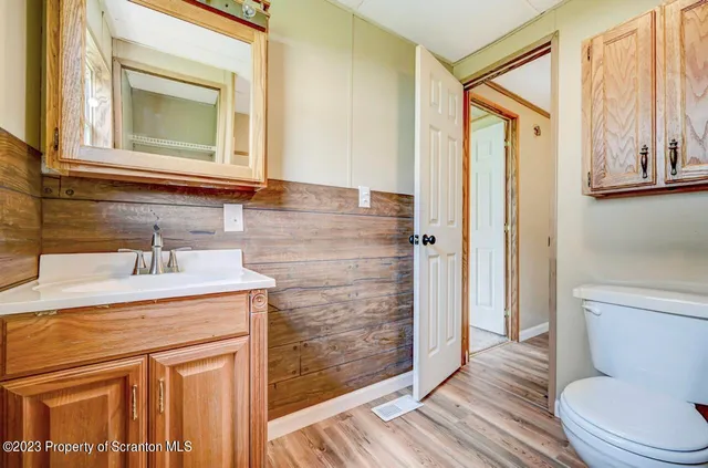 a bathroom with a shower a toilet and a sink