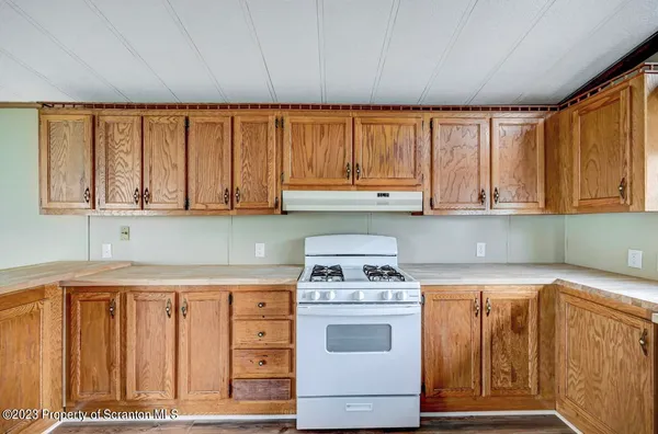a kitchen with appliances cabinets and a window