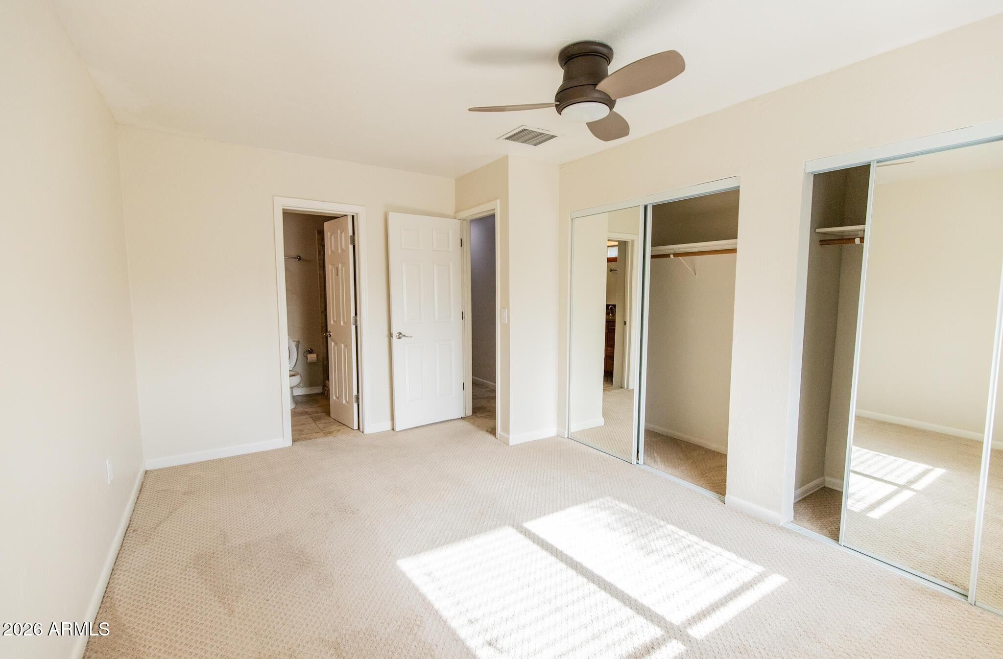 1029 West Elna Rae Street Tempe, AZ 85281 - Photo 13 of 20 a view of a room with a ceiling fan and window