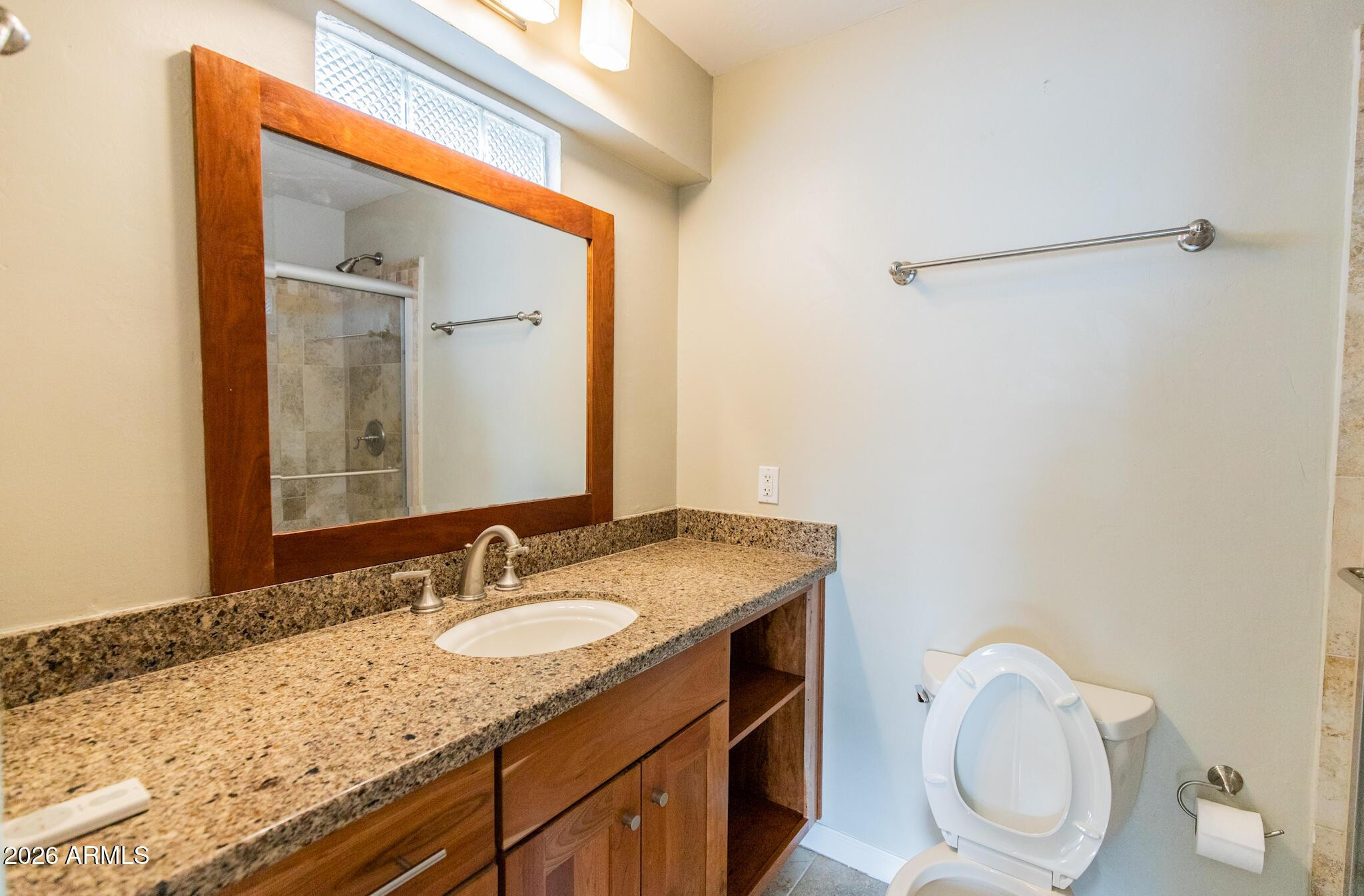 1029 West Elna Rae Street Tempe, AZ 85281 - Photo 14 of 20 a bathroom with a granite countertop sink and a mirror