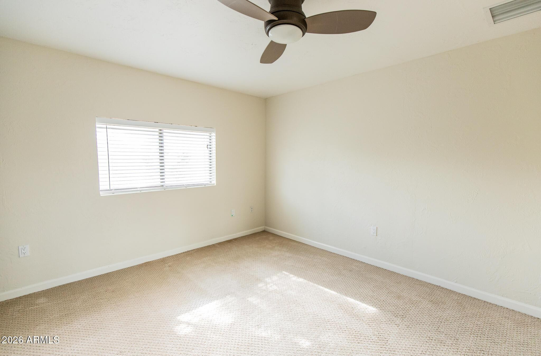 1029 West Elna Rae Street Tempe, AZ 85281 - Photo 16 of 20 an empty room with a window