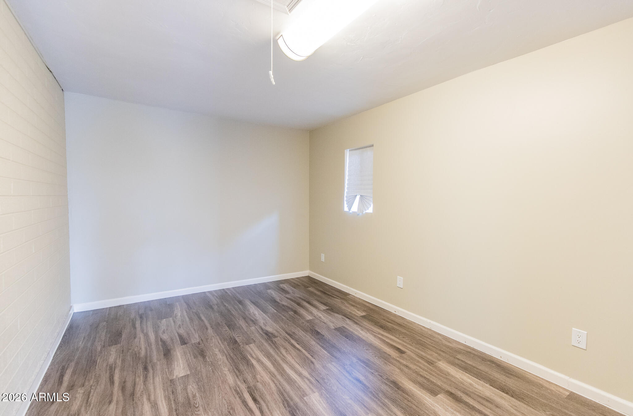 1029 West Elna Rae Street Tempe, AZ 85281 - Photo 17 of 20 a view of an empty room with wooden floor