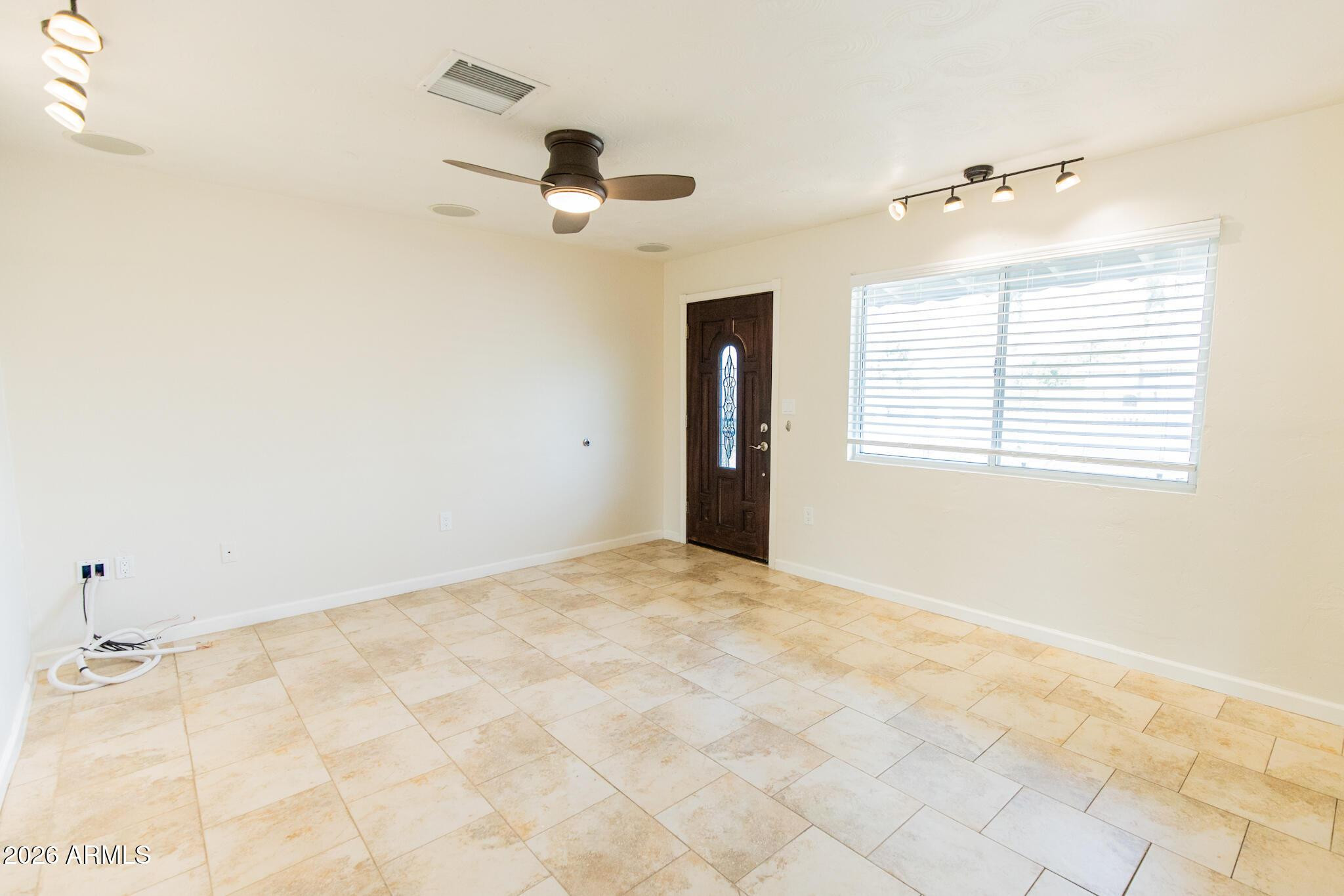 1029 West Elna Rae Street Tempe, AZ 85281 - Photo 2 of 20 a view of an empty room with a window