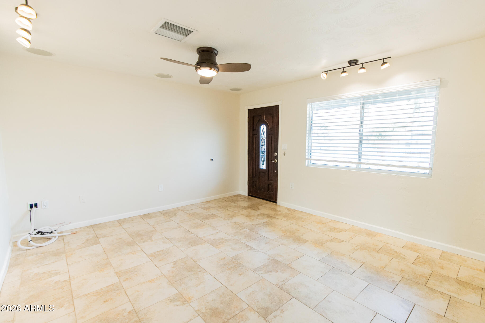 1029 West Elna Rae Street Tempe, AZ 85281 - Photo 2 of 20 a view of an empty room with a window
