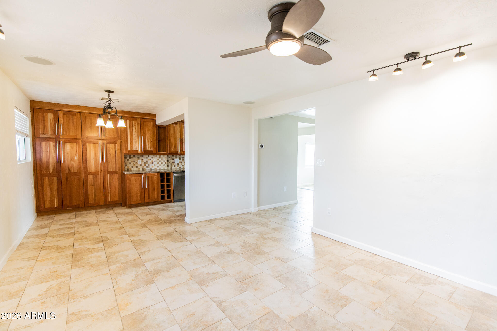 1029 West Elna Rae Street Tempe, AZ 85281 - Photo 3 of 20 a view of a kitchen with a sink and a chandelier fan